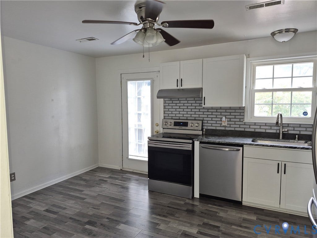 9324 Shiloh Drive, Chesterfield, VA 23237 Kitchen featuring wood-finish flooring, white cabinetry, dark countertops, a subway tile backsplash, and stainless steel appliances