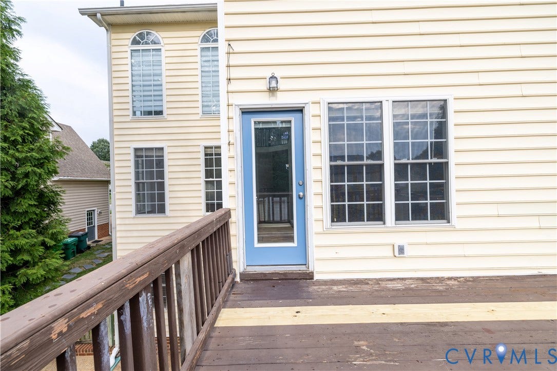 Upper-level wood deck with wood railing