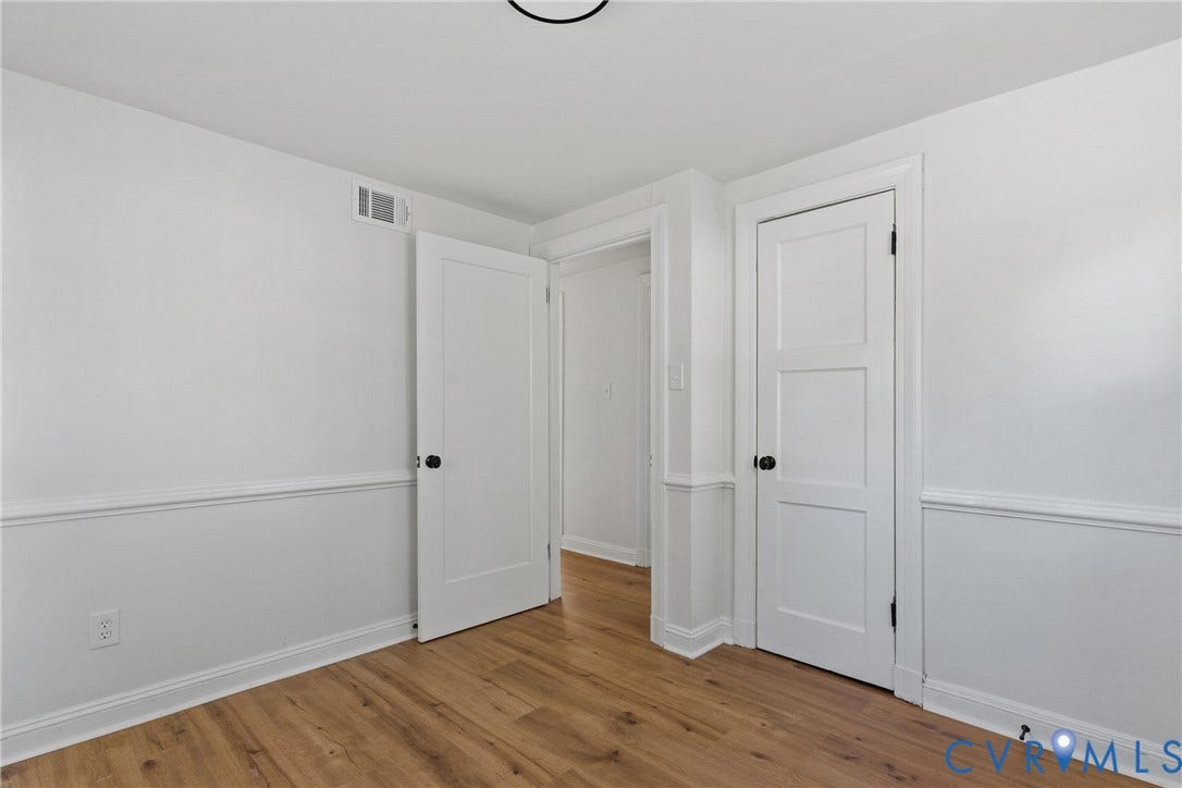 7406 Alycia Avenue, Henrico, VA 23228 Wood-finish flooring, white walls, and bright white trim