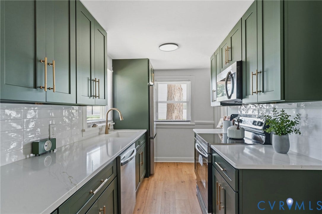 7406 Alycia Avenue, Henrico, VA 23228 Galley kitchen with dark green cabinetry, white textured subway tile backsplash, white countertops, and wood-finish flooring