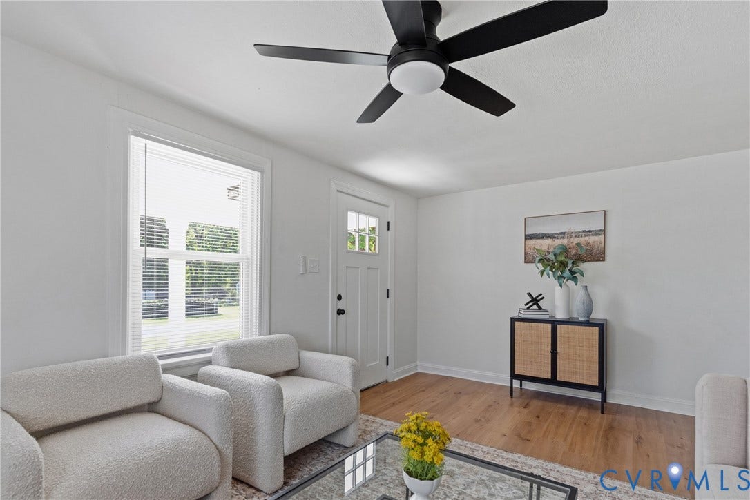 7406 Alycia Avenue, Henrico, VA 23228 Bright interior with wood-finish flooring, a white paneled entry door with glass inserts, and a black ceiling fan with an integrated light