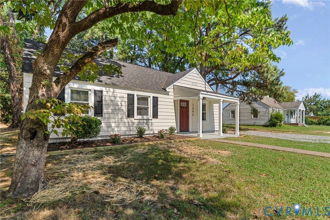 7406 Alycia Avenue, Henrico, VA 23228 White siding exterior with black window shutters, a red entry door, a covered porch, and a paved driveway
