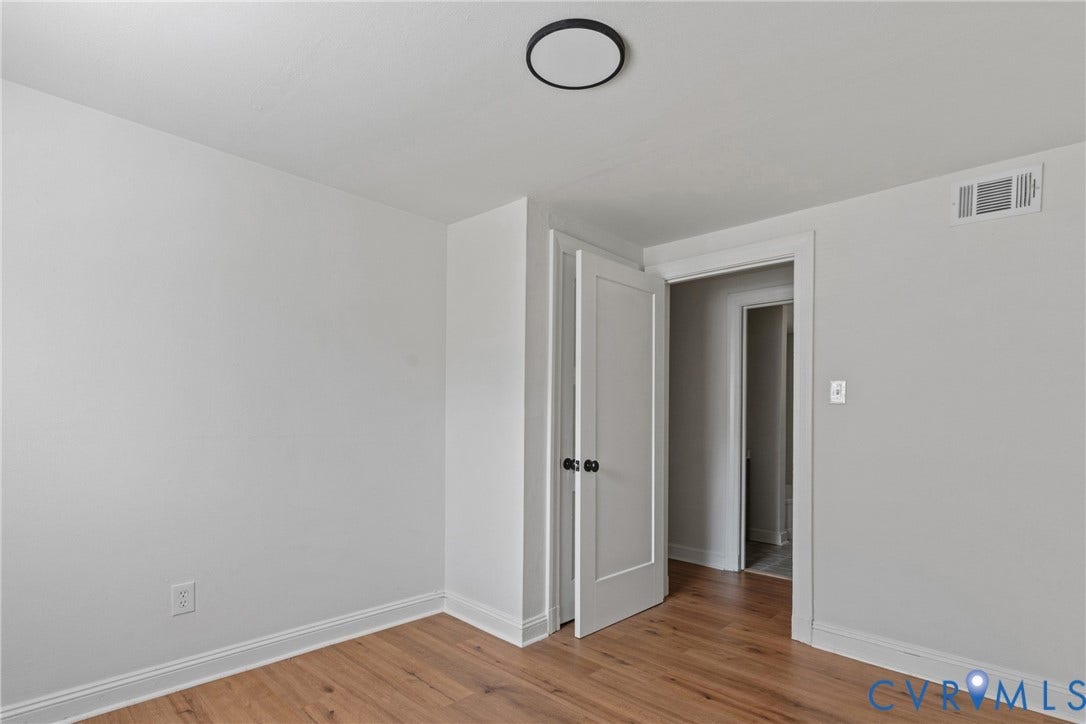 7406 Alycia Avenue, Henrico, VA 23228 Wood-finish flooring, white trim, recessed lighting, and a solid core door with matte black hardware
