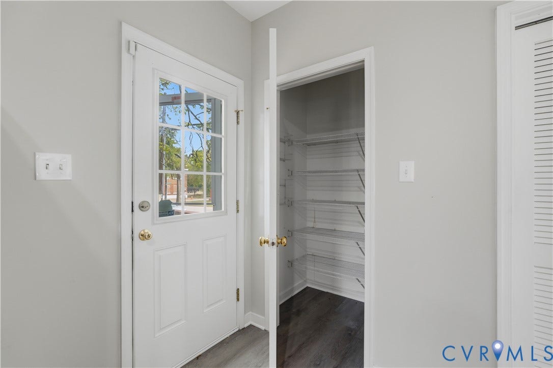124 Lipscomb Street, Blackwell, Richmond, VA 23224 White paneled door with glass inserts, wire shelving, and wood-finish flooring