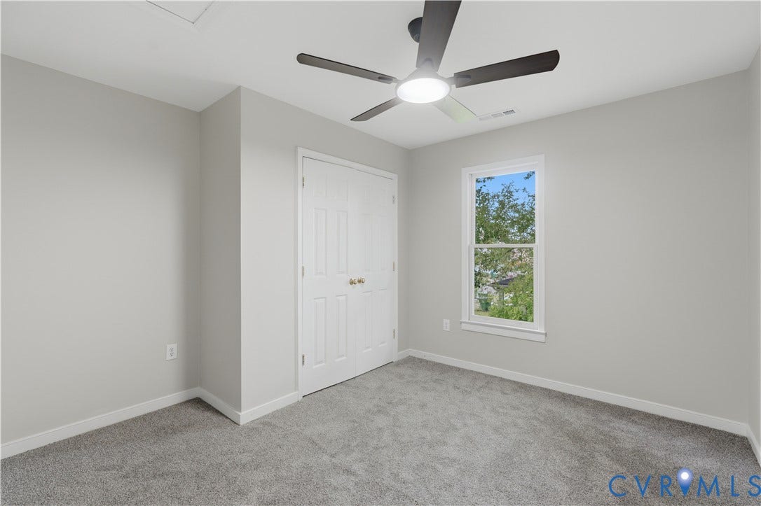 124 Lipscomb Street, Blackwell, Richmond, VA 23224 Neutral paint palette with gray carpeting, a ceiling fan with integrated lighting, and a double-door closet