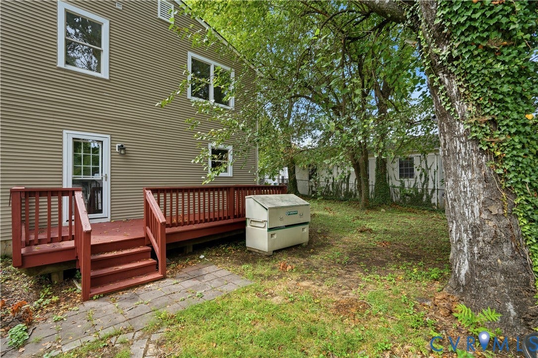 124 Lipscomb Street, Blackwell, Richmond, VA 23224 Exterior featuring horizontal siding, white-framed windows, and a red-toned wooden deck with railings and steps