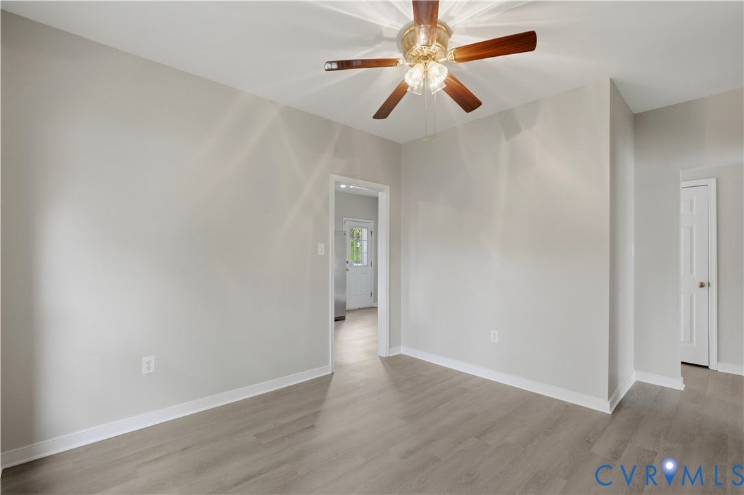 124 Lipscomb Street, Blackwell, Richmond, VA 23224 Laminate wood-finish flooring, light neutral wall paint, and a ceiling fan with integrated lighting