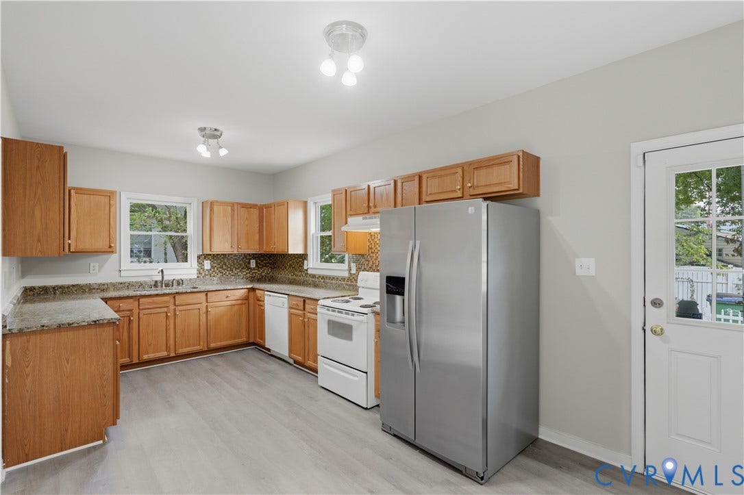 124 Lipscomb Street, Blackwell, Richmond, VA 23224 Kitchen featuring wood-finish cabinetry, light gray wood-finish flooring, a mosaic tile backsplash, and a stainless steel side-by-side refrigerator