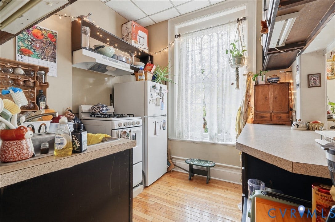 1505 Grove Avenue, Fan, Richmond, VA 23220 Hardwood flooring, kitchen window, built-in shelving, range with overhead exhaust, and a refrigerator