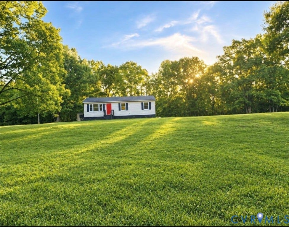 1605 Cartersville Road, Quiet, Goochland, VA 23063 Expansive green lawn surrounds a single-story residence with a red entry door, white siding, and dark shutters