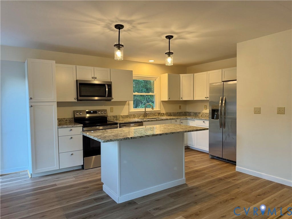 1605 Cartersville Road, Quiet, Goochland, VA 23063 Kitchen featuring white cabinetry, wood-finish flooring, stainless steel appliances, granite countertops, and a central island