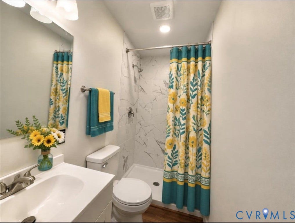 1605 Cartersville Road, Quiet, Goochland, VA 23063 VIRTUALLY STAGED: White vanity with an integrated sink and brushed nickel faucet, large wall mirror, and overhead light fixture