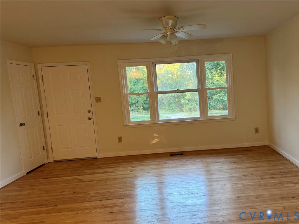 1605 Cartersville Road, Quiet, Goochland, VA 23063 Hardwood flooring, painted walls, ceiling fan, white paneled doors, and a multi-pane window