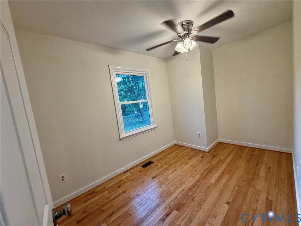 1605 Cartersville Road, Quiet, Goochland, VA 23063 Hardwood flooring, painted walls, white trim, single window, and a ceiling fan with integrated lighting