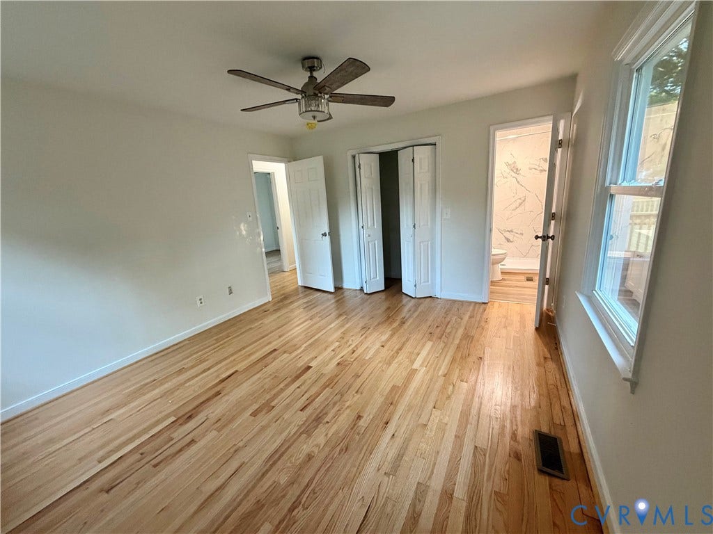 1605 Cartersville Road, Quiet, Goochland, VA 23063 Hardwood flooring, ceiling fan with integrated lighting, white interior doors, and a double-hung window