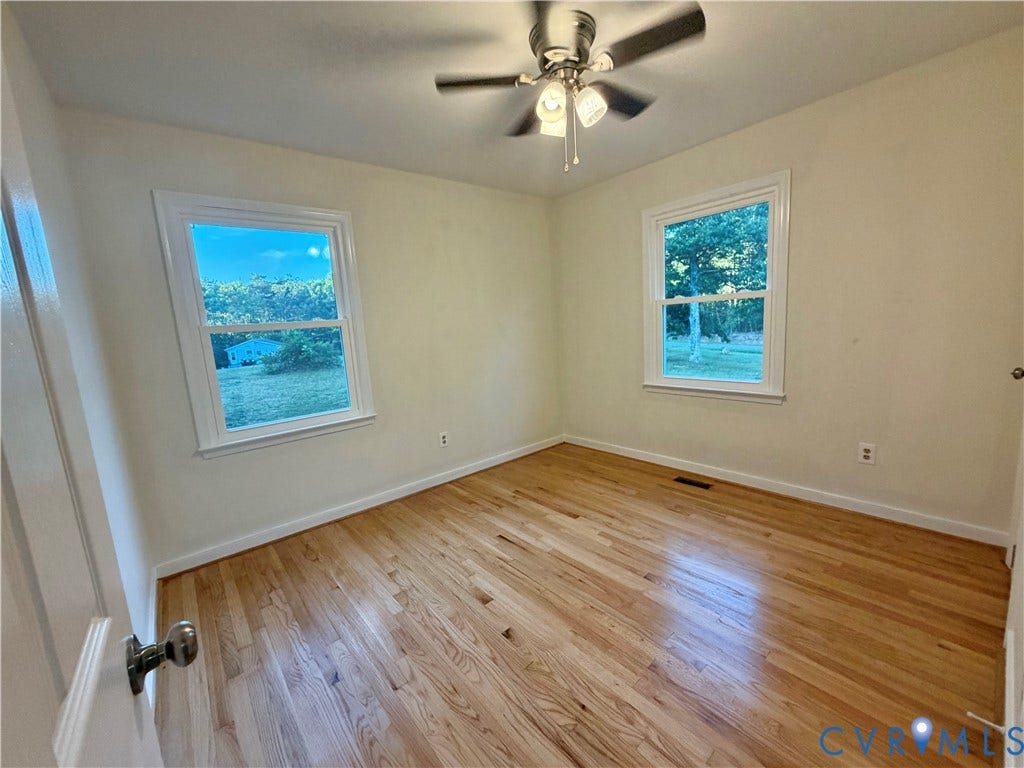 1605 Cartersville Road, Quiet, Goochland, VA 23063 Hardwood flooring throughout, two double-hung windows, and a ceiling fan with integrated lighting