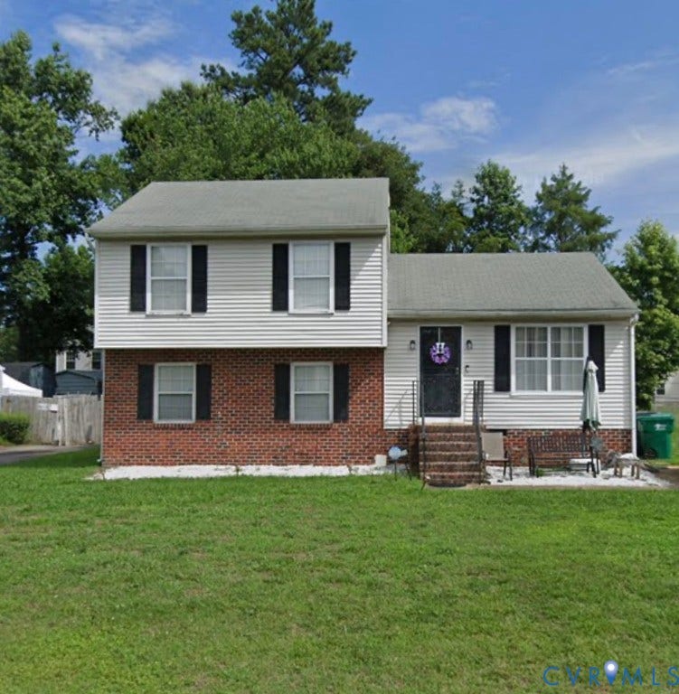 3826 Tighe Court, Henrico, VA 23223 Two-story residence featuring brick and siding exterior, front porch with steps and railings, and a manicured lawn