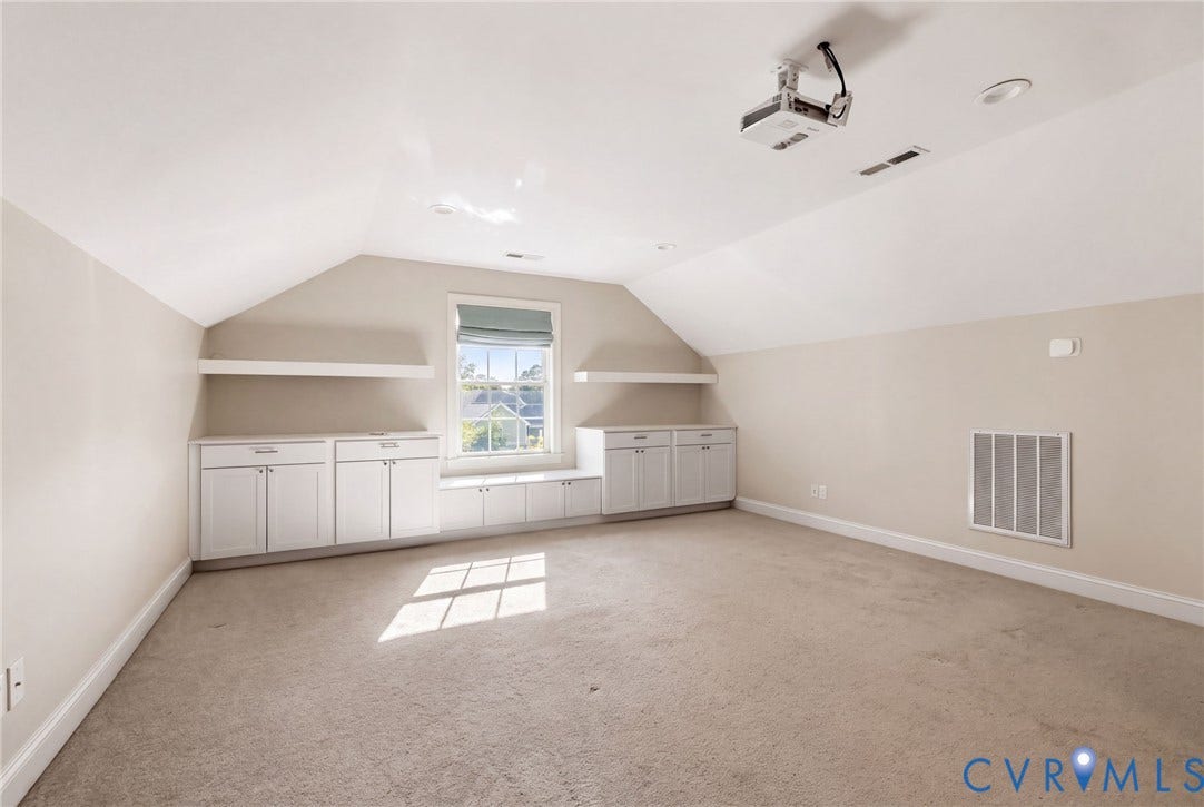 Vaulted ceiling with a mounted projector, recessed lighting, built-in cabinetry, and integrated shelving