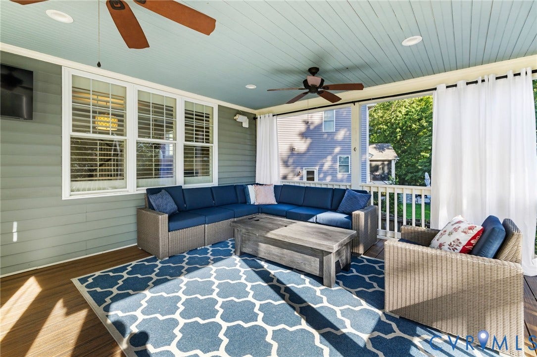 Covered porch featuring wood-finish flooring, a beadboard ceiling, white railing, and multiple windows