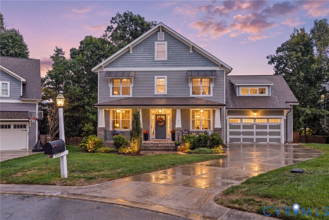 Two-story home with a covered front porch and stone accents