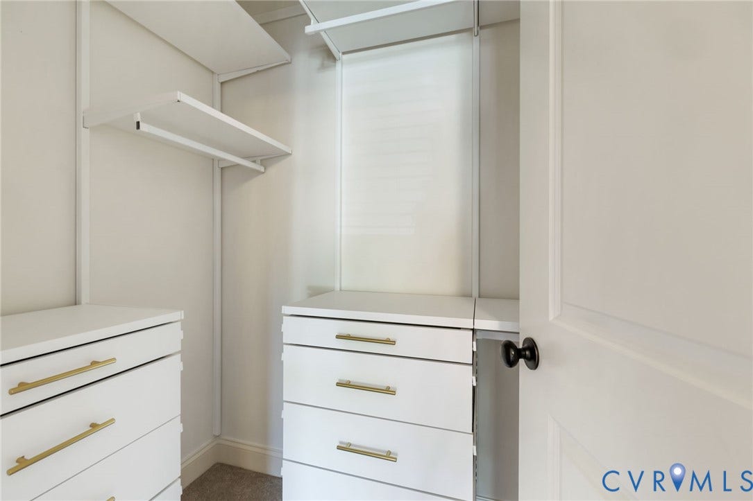 Built-in closet system featuring multiple shelves and hanging rods