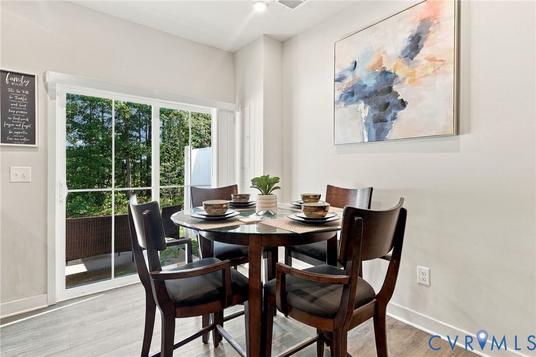 Sliding glass door leading to an outdoor space, recessed lighting, and wood-finish flooring