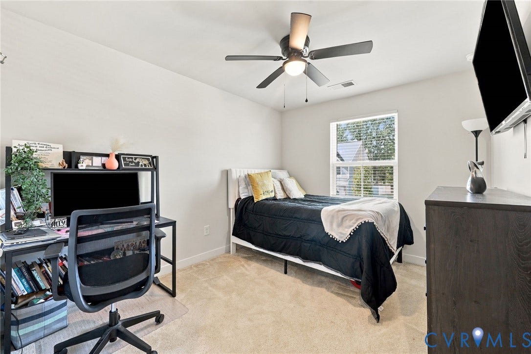 Neutral-toned walls complement a carpeted floor