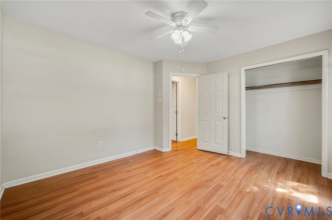 3530 Glisson Road, Richmond, VA 23237 Wood-finish flooring throughout, white ceiling fan with light fixture, and an open closet with a clothes rod