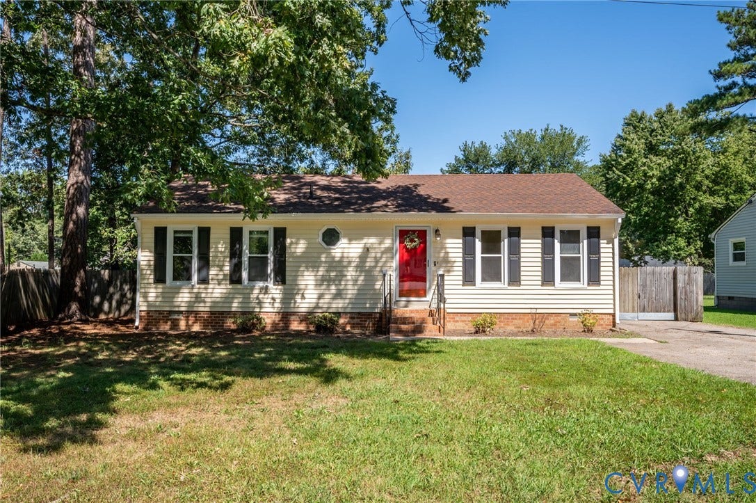 3530 Glisson Road, Richmond, VA 23237 Yellow siding exterior with dark shutters, red front door, and a circular window