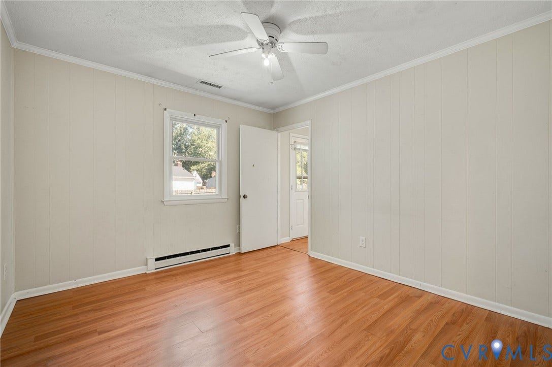 3530 Glisson Road, Richmond, VA 23237 Wood-finish flooring, white paneled walls, ceiling fan, and window with exterior views