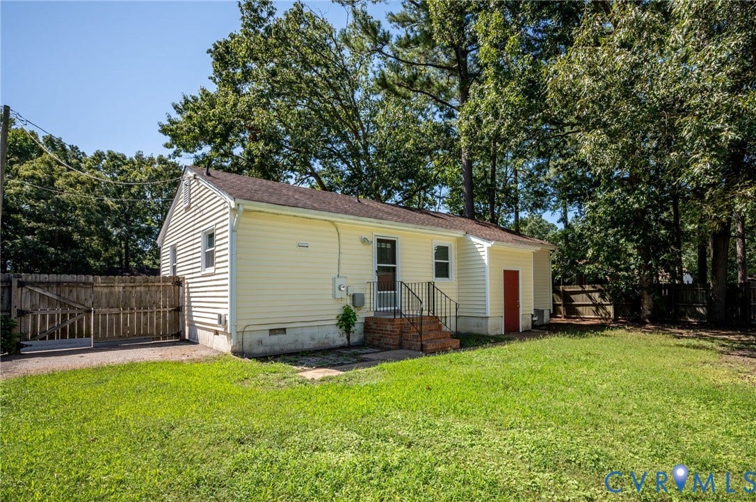 3530 Glisson Road, Richmond, VA 23237 Yellow siding exterior with white trim, a brown shingle roof, and a red rear entry door