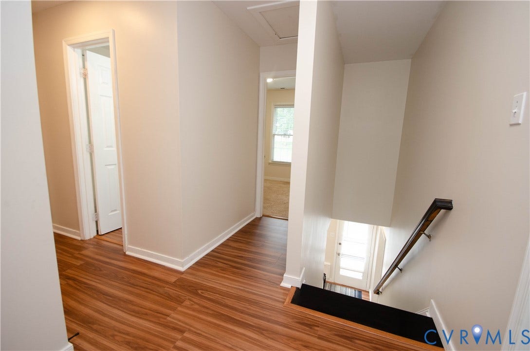 Wood-finish flooring throughout the hallway