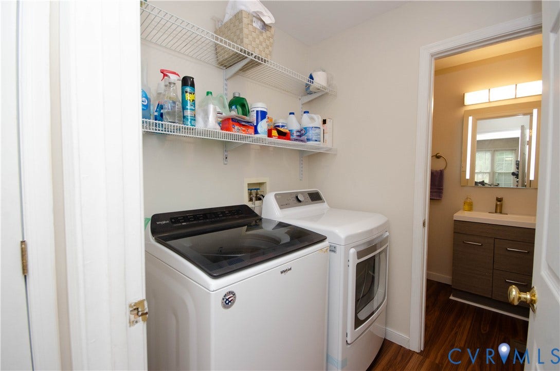 Laundry area with wire shelving and wood-finish flooring