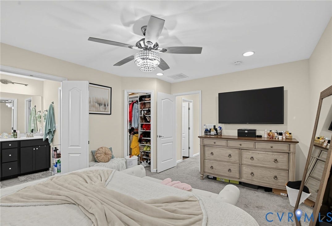 Plush carpeting, recessed lighting, and a contemporary ceiling fan with a chandelier light kit