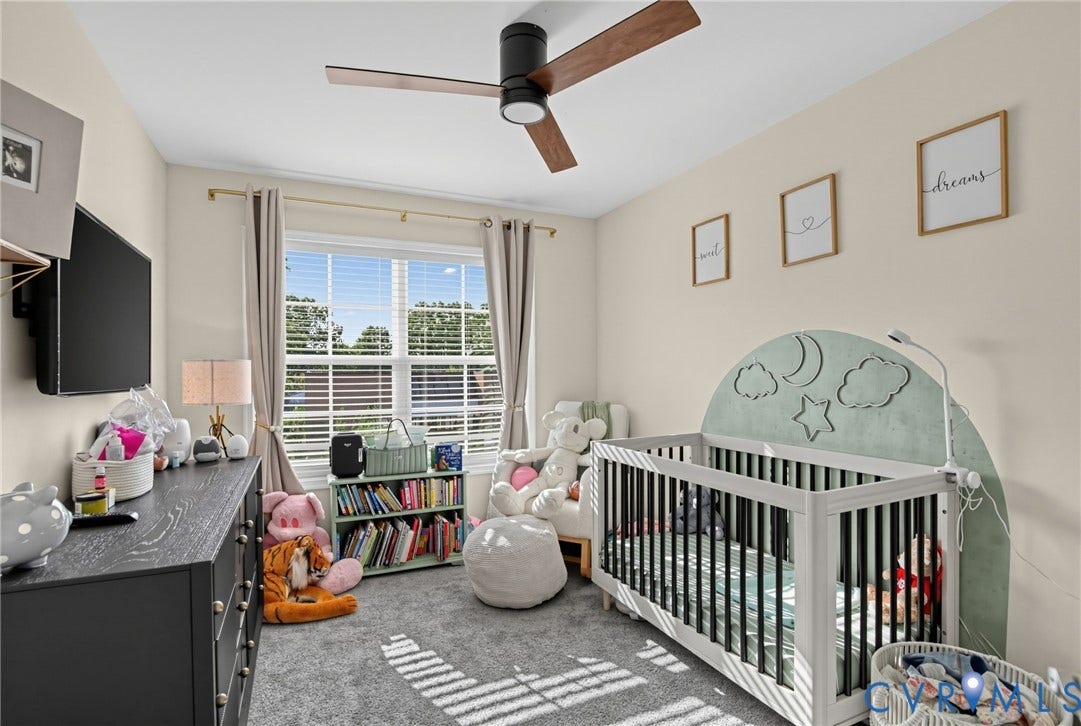 Ceiling fan with wood-finish blades, recessed lighting, and large window with blinds