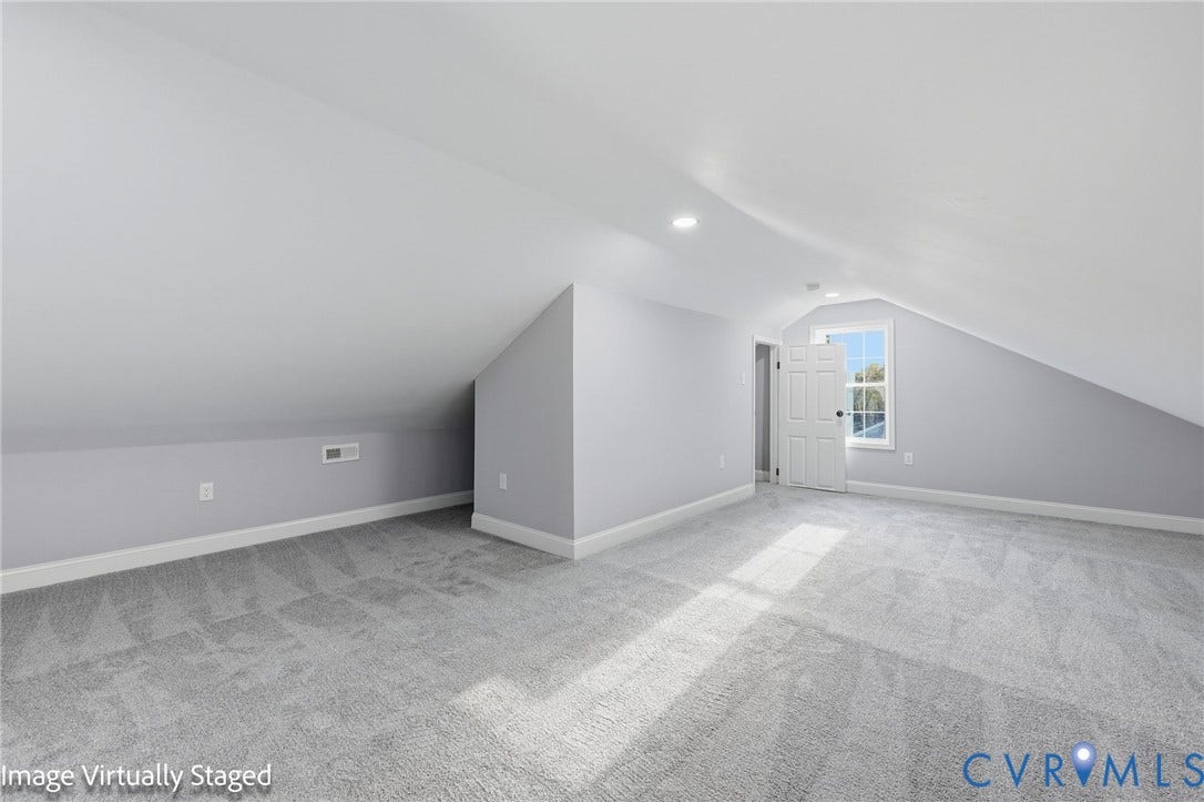 510 N Carolina Avenue, Petersburg, VA 23803 Spacious interior featuring sloped ceilings, recessed lighting, carpet flooring, a window, and a door with black hardware