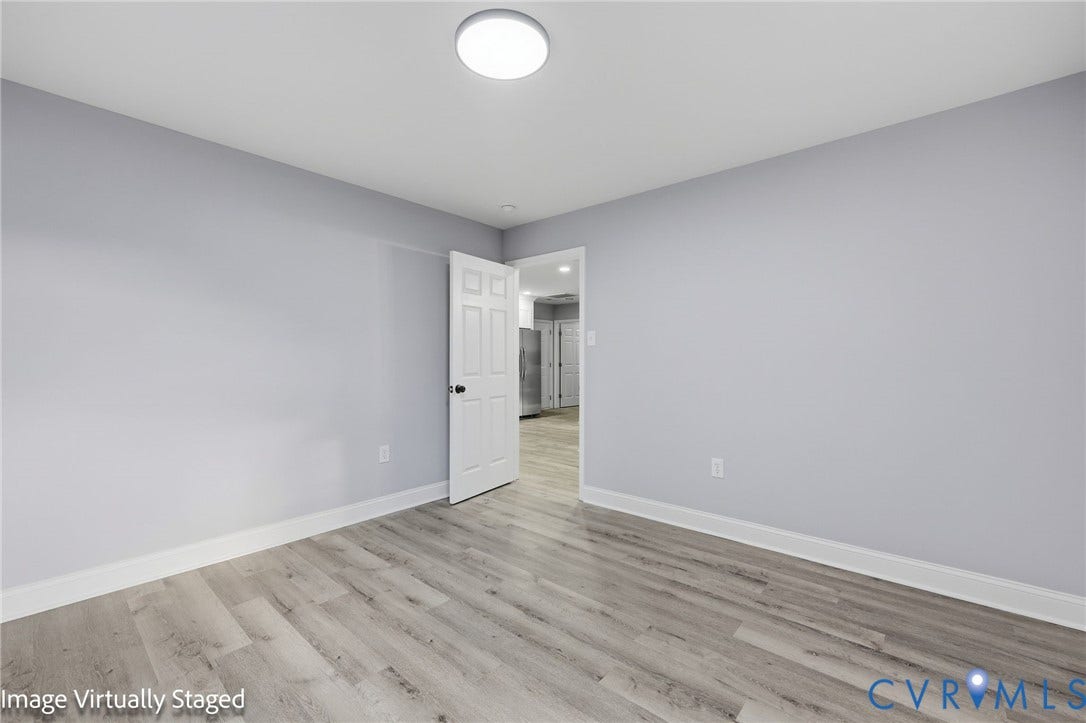 510 N Carolina Avenue, Petersburg, VA 23803 Light gray wall paint, wood-finish flooring, flush mount ceiling light, and white interior door