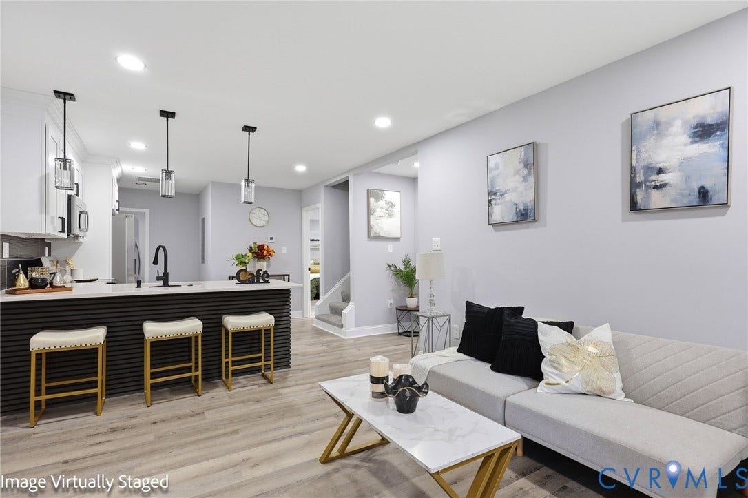 510 N Carolina Avenue, Petersburg, VA 23803 Open-concept living space with wood-finish flooring, recessed lighting, and a kitchen island featuring three pendant lights