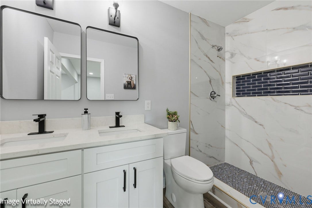 510 N Carolina Avenue, Petersburg, VA 23803 Double vanity with quartz countertop, dual matte black faucets, and rectangular mirrors