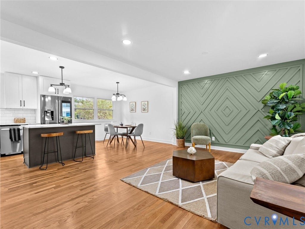 7361 Creekridge Road, Henrico, VA 23231 Expansive living area featuring wood-finish flooring, a decorative accent wall, a kitchen island with seating, stainless steel appliances, and recessed lighting