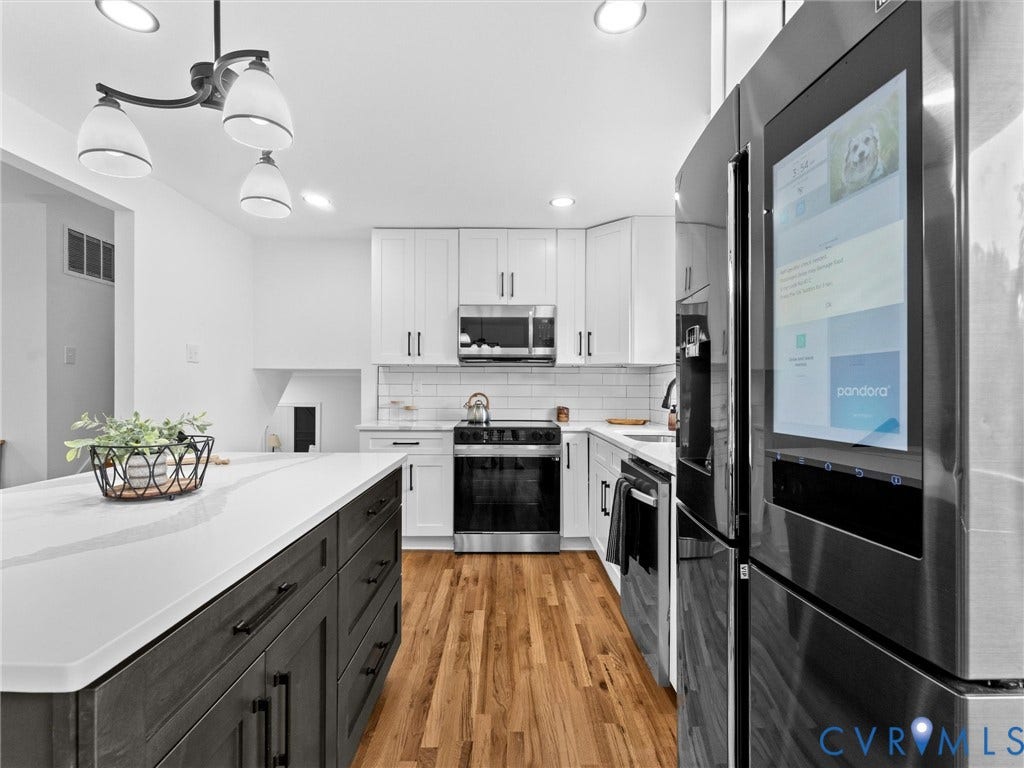 7361 Creekridge Road, Henrico, VA 23231 Kitchen featuring a center island with a white countertop, wood-finish flooring, white subway tile backsplash, and stainless steel appliances