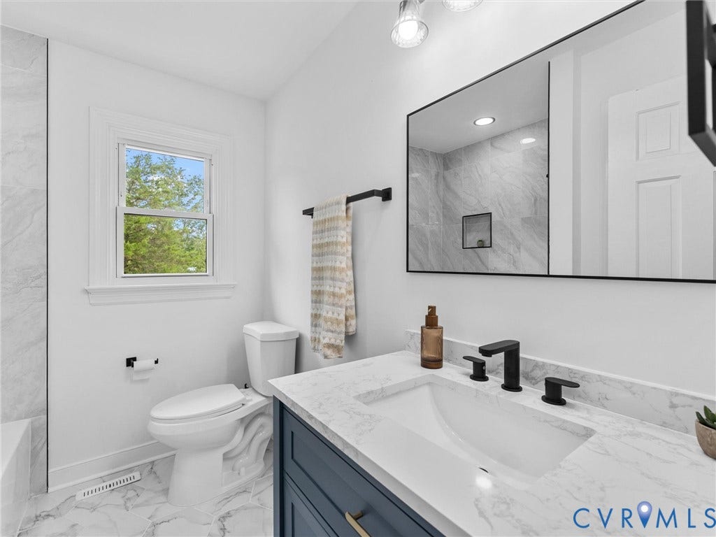 7361 Creekridge Road, Henrico, VA 23231 Bathroom featuring a vanity with a stone countertop, integrated sink, and matte black fixtures