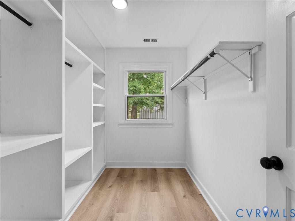 7361 Creekridge Road, Henrico, VA 23231 Built-in shelving and hanging rods, wood-finish flooring, and natural light from the window