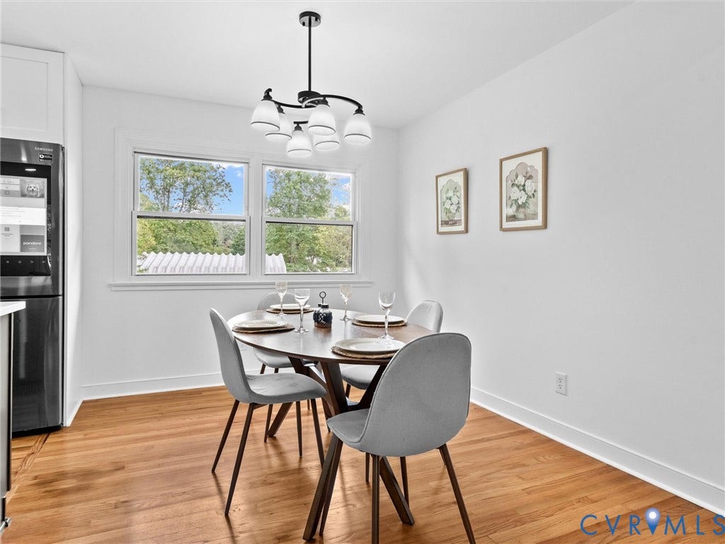 7361 Creekridge Road, Henrico, VA 23231 Hardwood flooring, white wall paint, dual windows with white trim, recessed lighting, and a modern chandelier