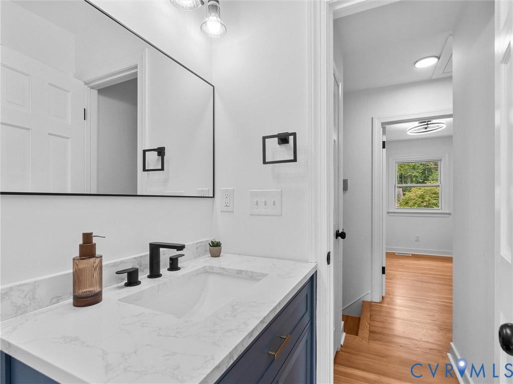 7361 Creekridge Road, Henrico, VA 23231 Vanity with a solid surface countertop, undermount sink, and matte black fixtures