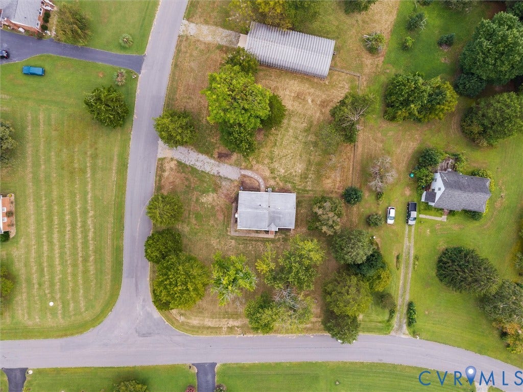 7361 Creekridge Road, Henrico, VA 23231 Expansive property featuring multiple structures, mature trees, and paved road access