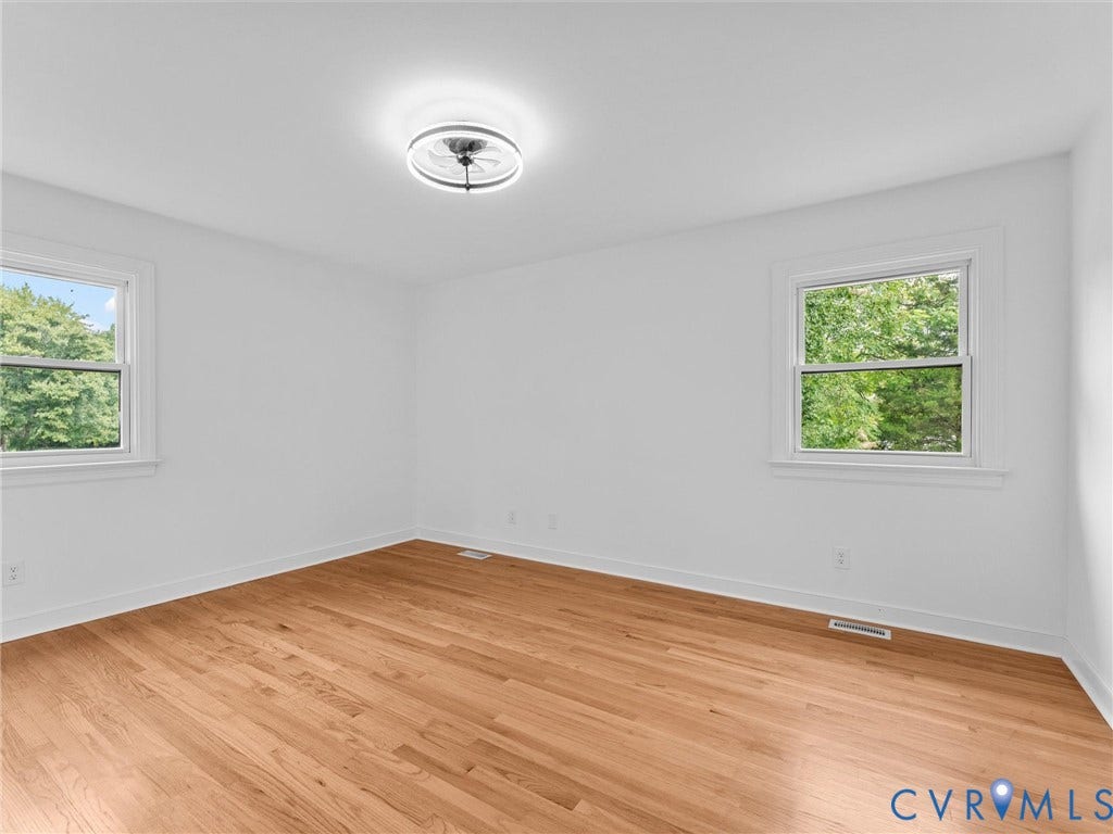 7361 Creekridge Road, Henrico, VA 23231 Wood-finish flooring, white walls, two windows with white trim, and a ceiling-mounted light fixture