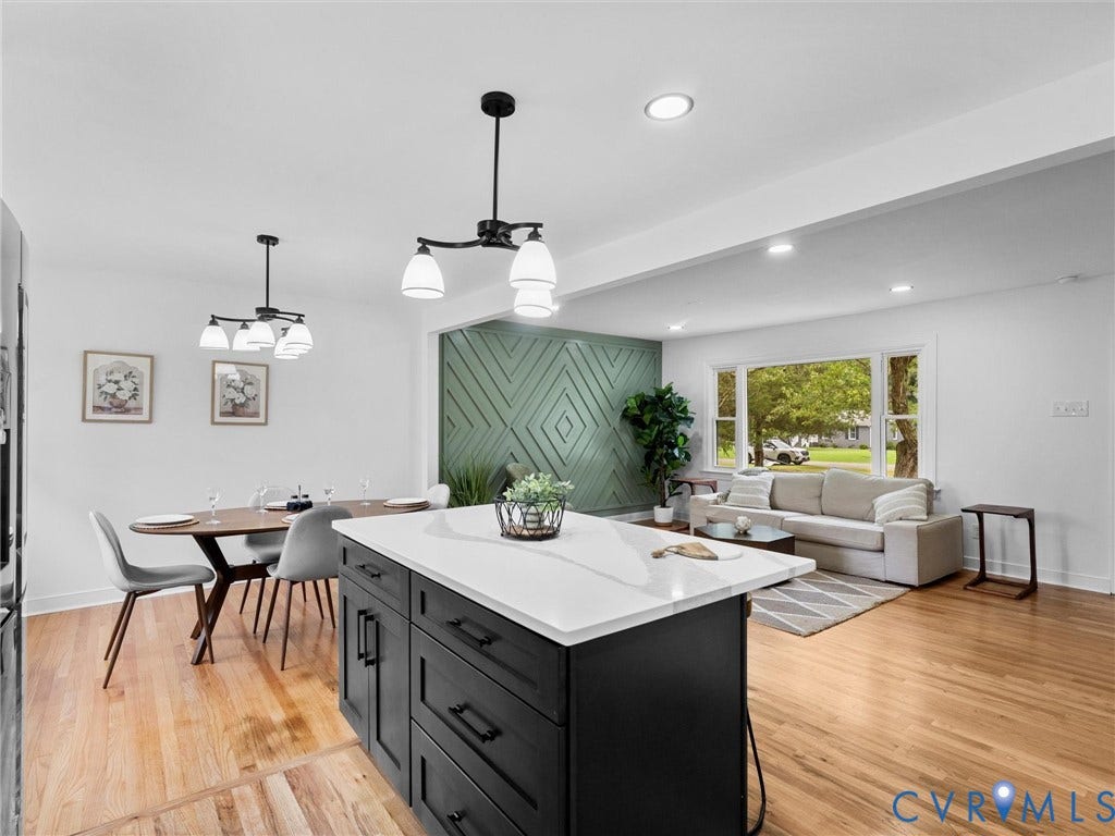 7361 Creekridge Road, Henrico, VA 23231 Open-concept living space with hardwood flooring, a central kitchen island with a light-toned countertop, recessed lighting, and a decorative accent wall
