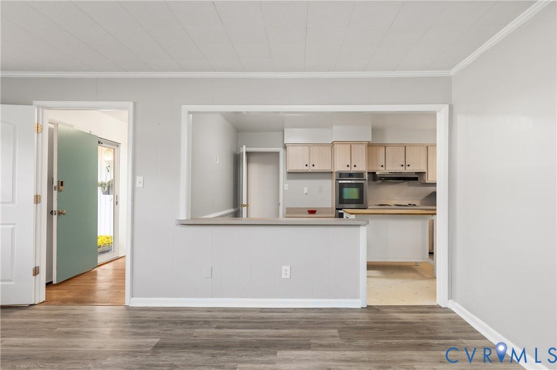 300 Gunby Drive, Henrico, VA 23229 Wood-finish flooring throughout the foreground with light gray wall paint and white trim