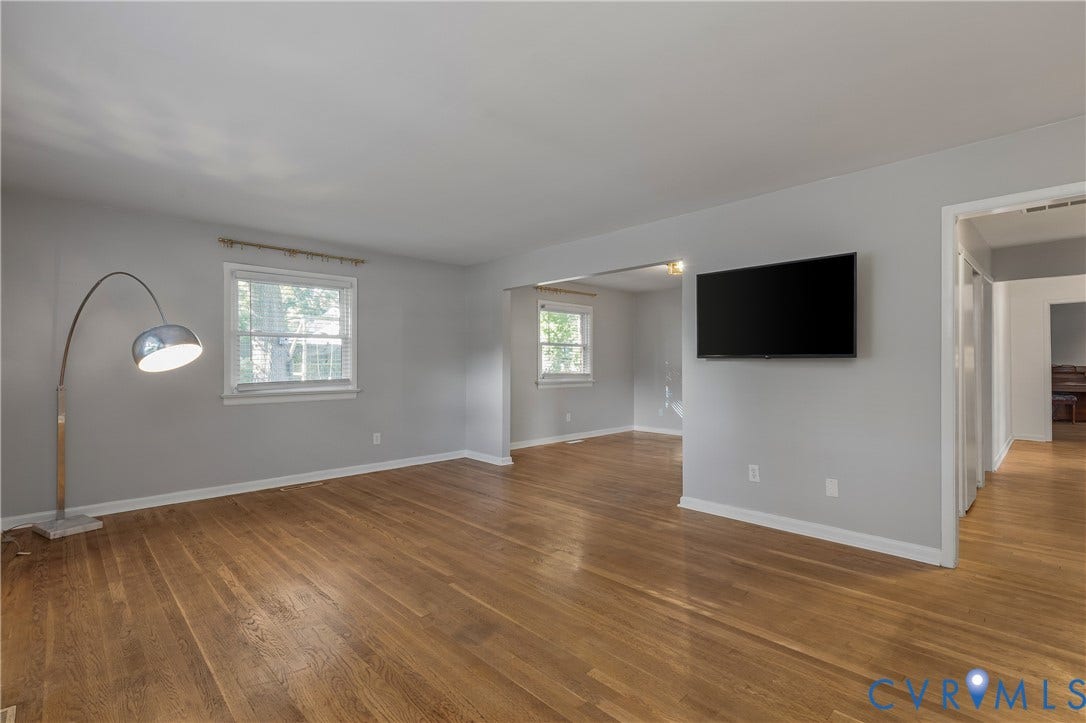 300 Gunby Drive, Henrico, VA 23229 Hardwood flooring, light gray wall paint, multiple windows, and a wall-mounted display